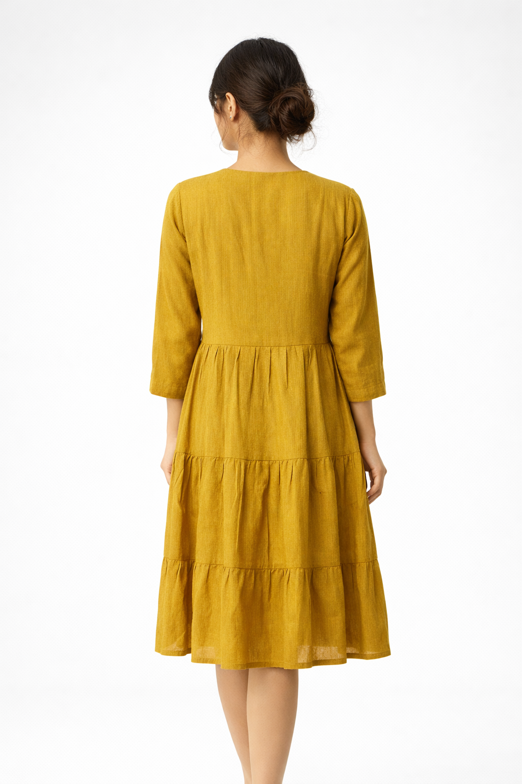 Bright and effortlessly stylish, this mustard yellow dress features a flowy tiered silhouette for a soft, feminine look.