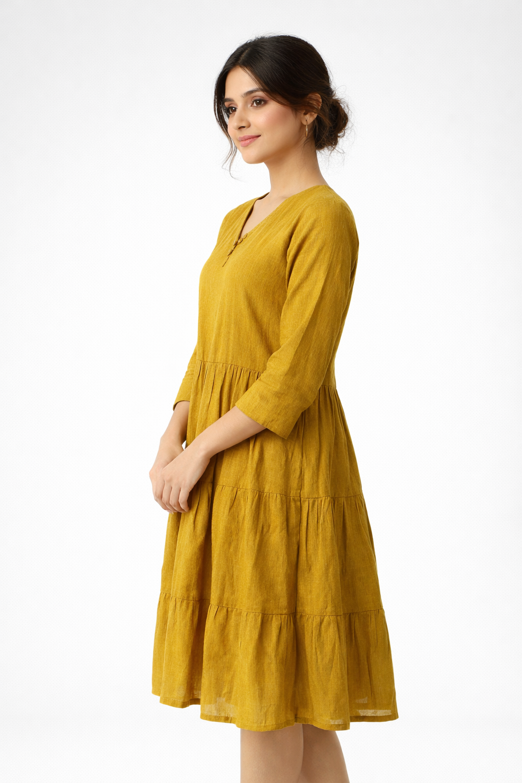 Bright and effortlessly stylish, this mustard yellow dress features a flowy tiered silhouette for a soft, feminine look.