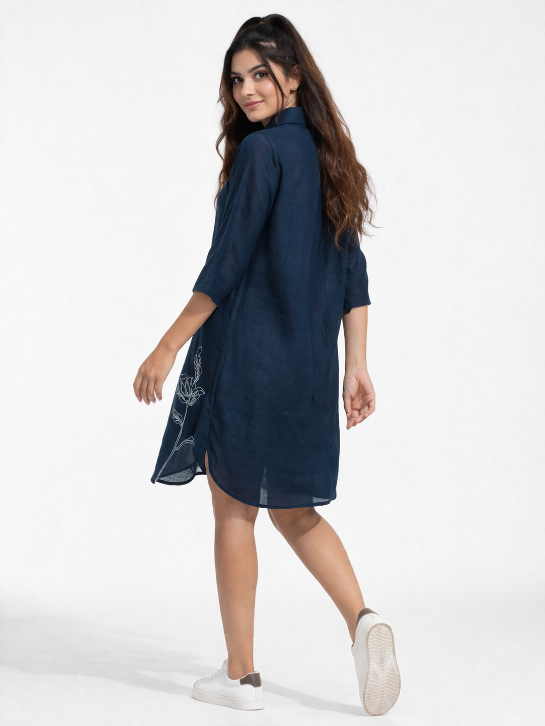 Elegant and effortlessly stylish, this navy blue shirt dress features a sleek silhouette with subtle white floral embroidery for a refined touch.