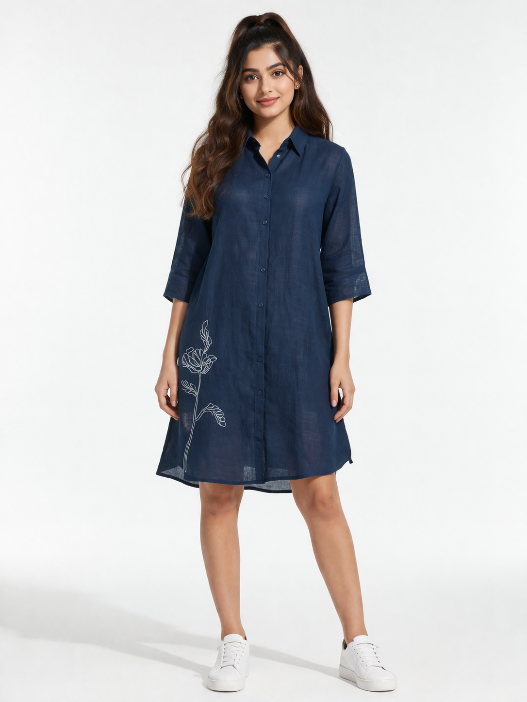 Elegant and effortlessly stylish, this navy blue shirt dress features a sleek silhouette with subtle white floral embroidery for a refined touch.