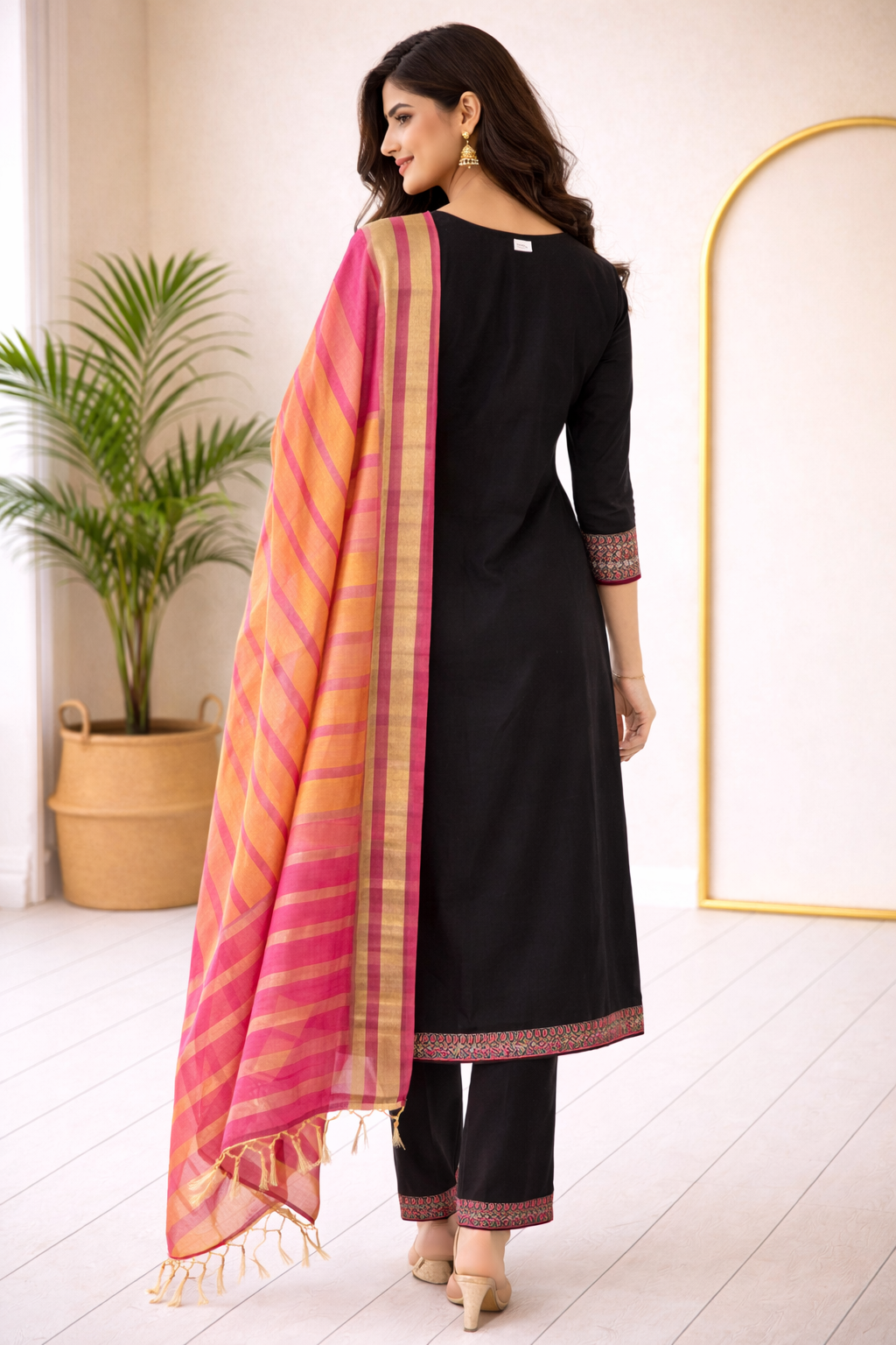 Elegant black straight-cut kurta set highlighted with rich magenta embroidery and paired with a vibrant pink-orange striped dupatta for a graceful festive look