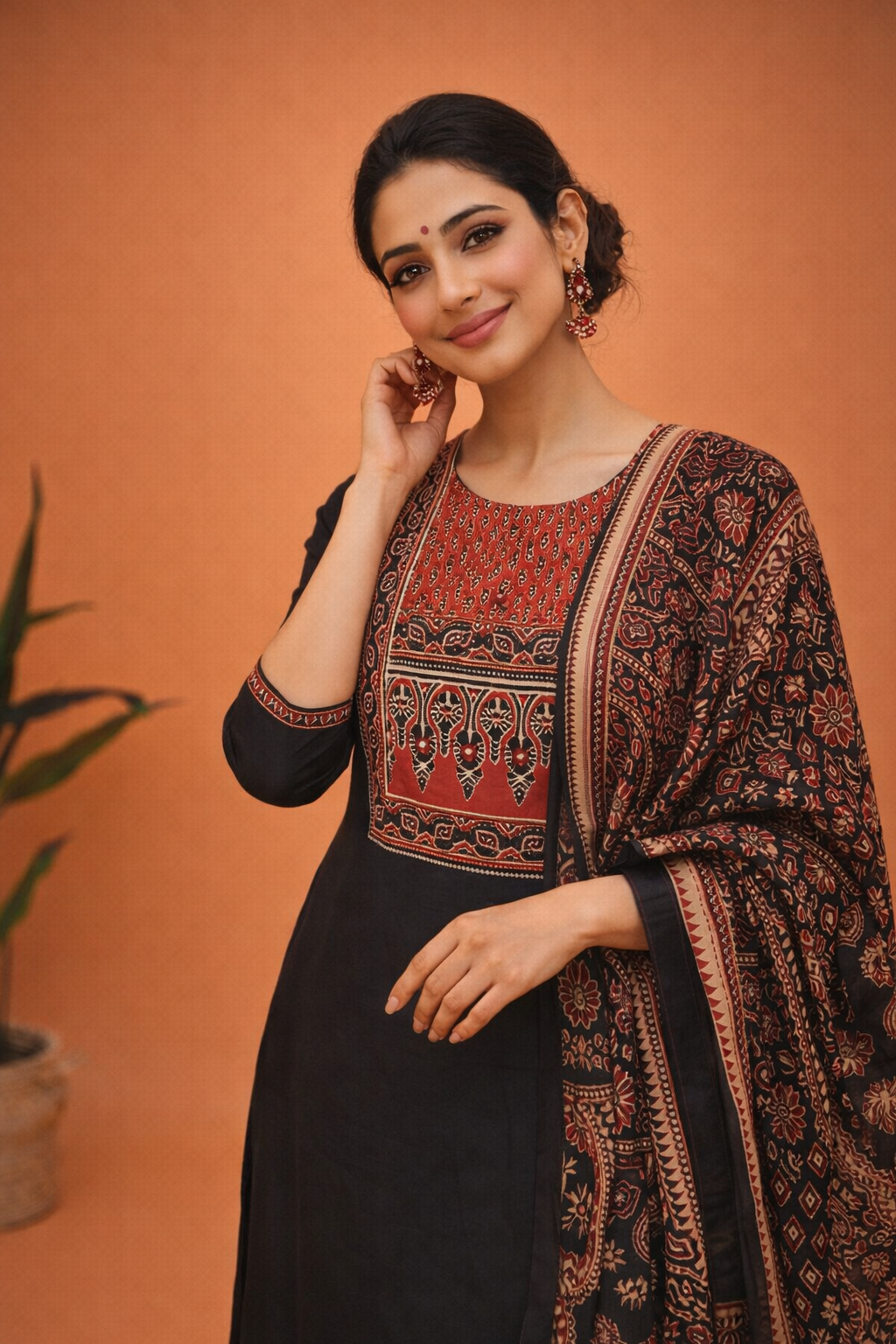 Elegant black suit with rich traditional prints and a beautifully detailed yoke, perfect for timeless ethnic style.
