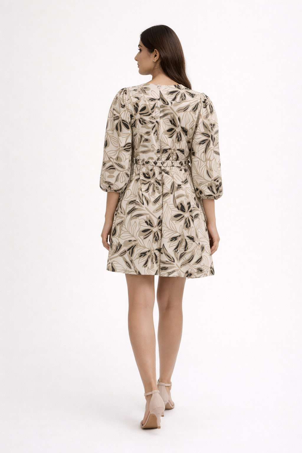 Chic and effortlessly feminine, this beige printed dress features a soft flowy silhouette with elegant abstract floral patterns.