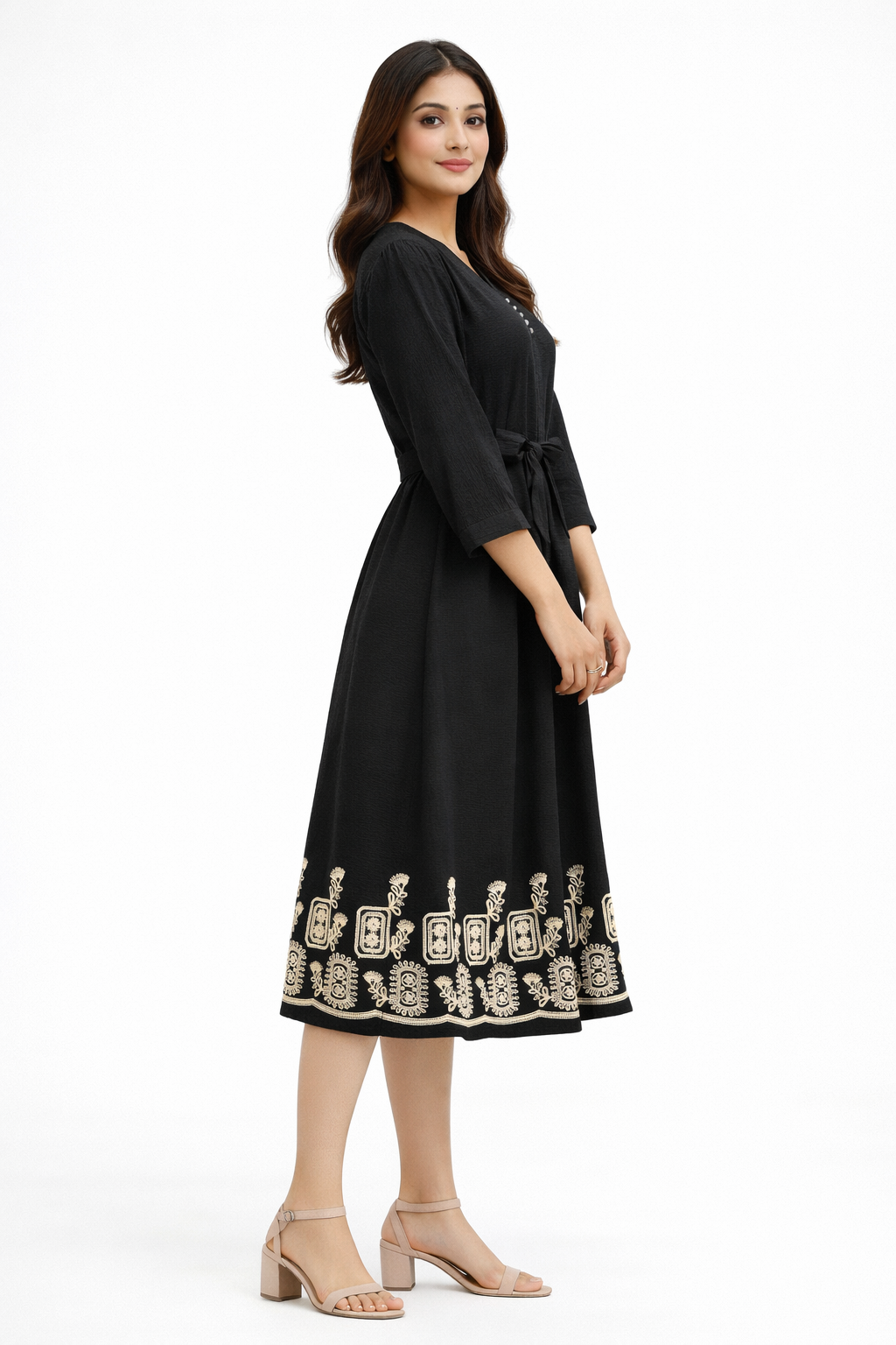Black midi dress features a flattering flowy silhouette with a delicate beige embroidered border