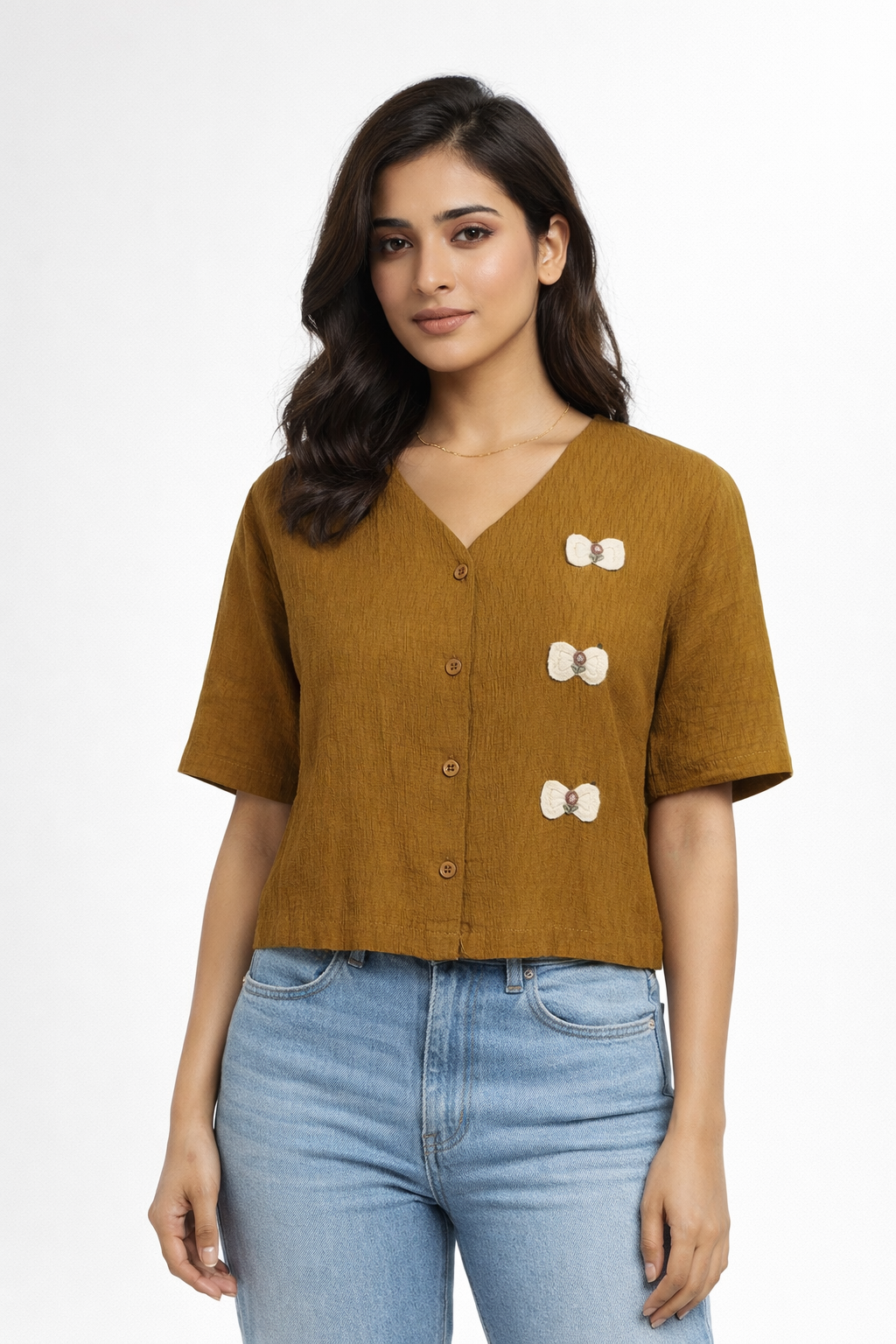 Top featuring a V-Neck line and short sleeves. Designed with finished h a relaxed silhouette and with a contrasting all-over abstract print Brown