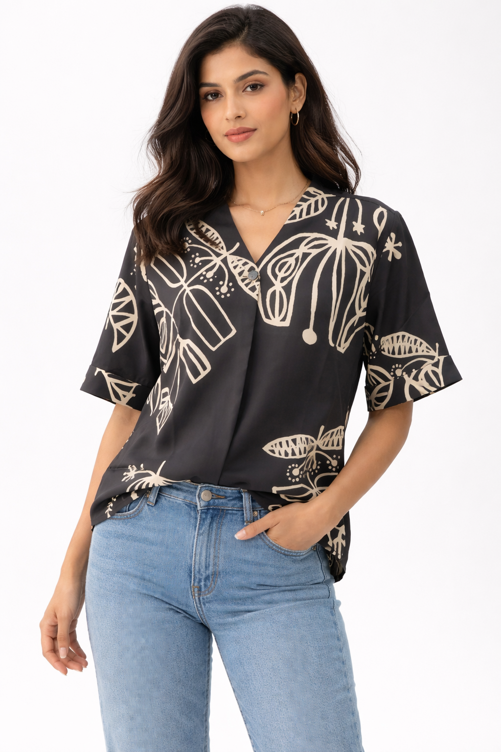 Top featuring a V-neckline and short sleeves. Designed with a relaxed silhouette and finished with a contrasting all-over abstract print