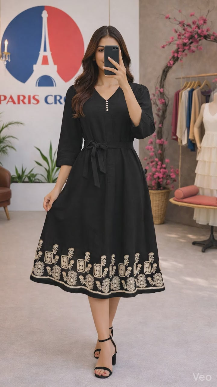Black midi dress features a flattering flowy silhouette with a delicate beige embroidered border